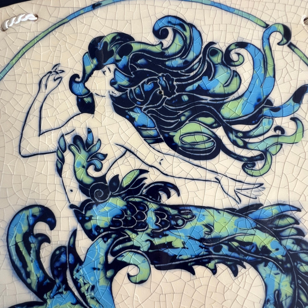 Decorative ceramic wall tile with Art Nouveau mermaid design on a crackle glaze background