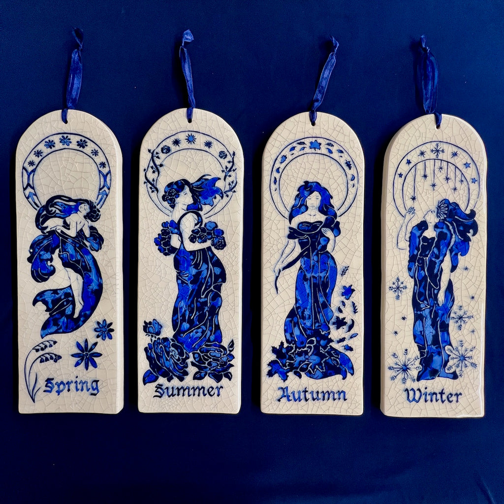 Four arch ceramic tiles hand carved with four Art Nouveau women representing Spring, Summer, Autumn, and Winter on a crackle glaze background.