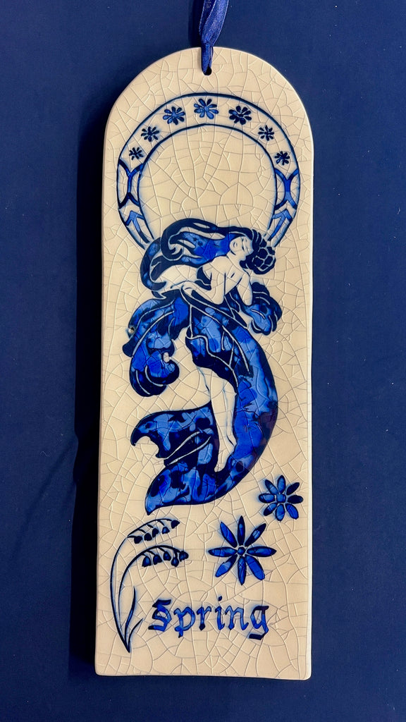 Arch ceramic tiles hand carved with Art Nouveau woman representing Spring on a crackle glaze background.