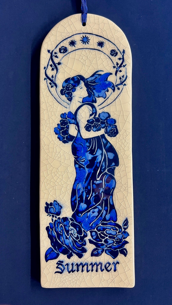 Arch ceramic tile hand carved with Art Nouveau woman representing Summer on a crackle glaze background.