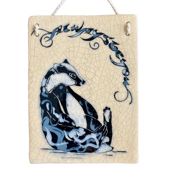 Decorative plaque with a stylized badger design on a beige background
