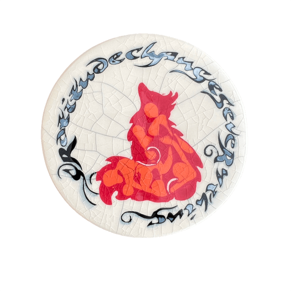 Round coaster with red and orange fox design on a crackle glaze background with the words "Gratitude changes everything."