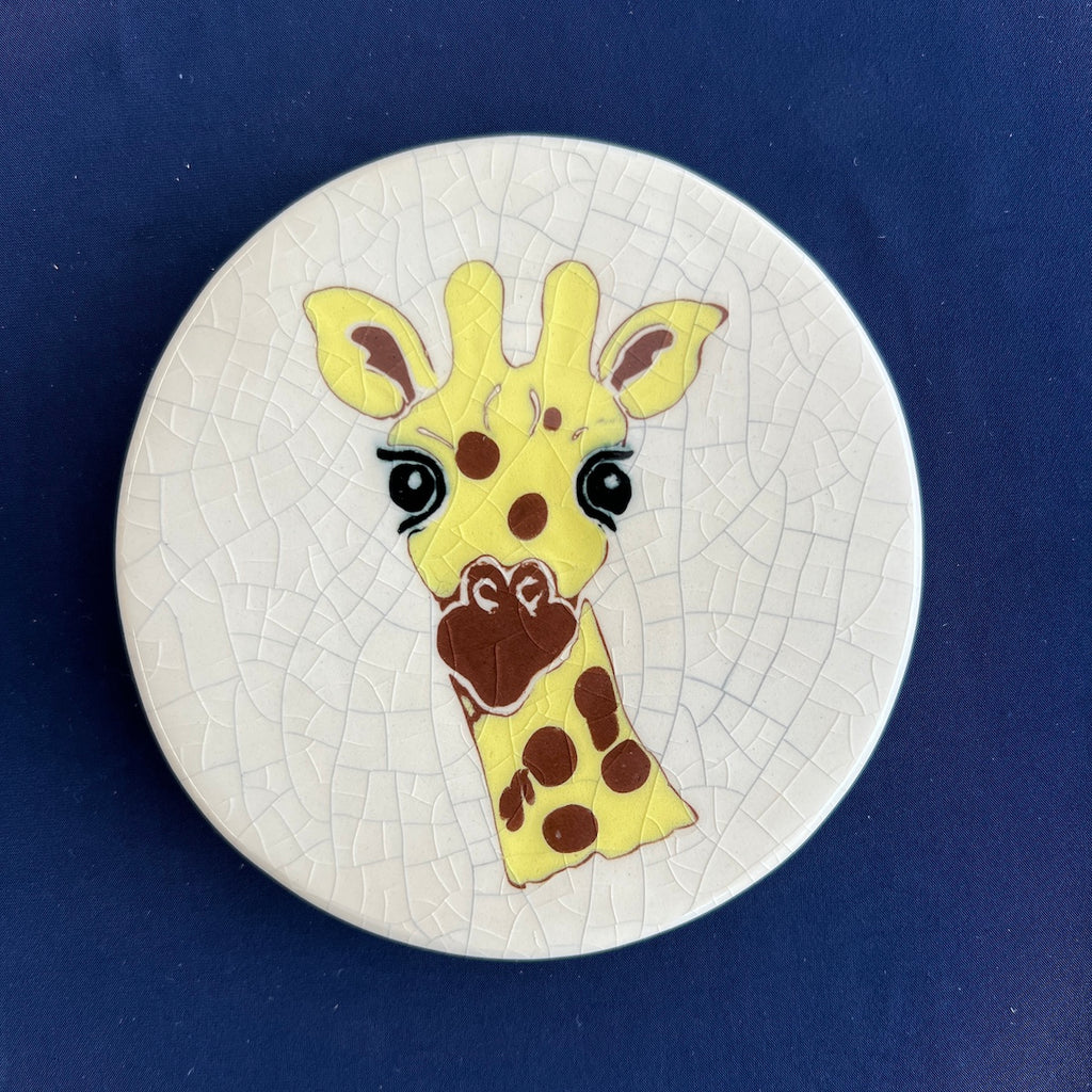 Round ceramic coaster with a giraffe design on a crackle glaze background