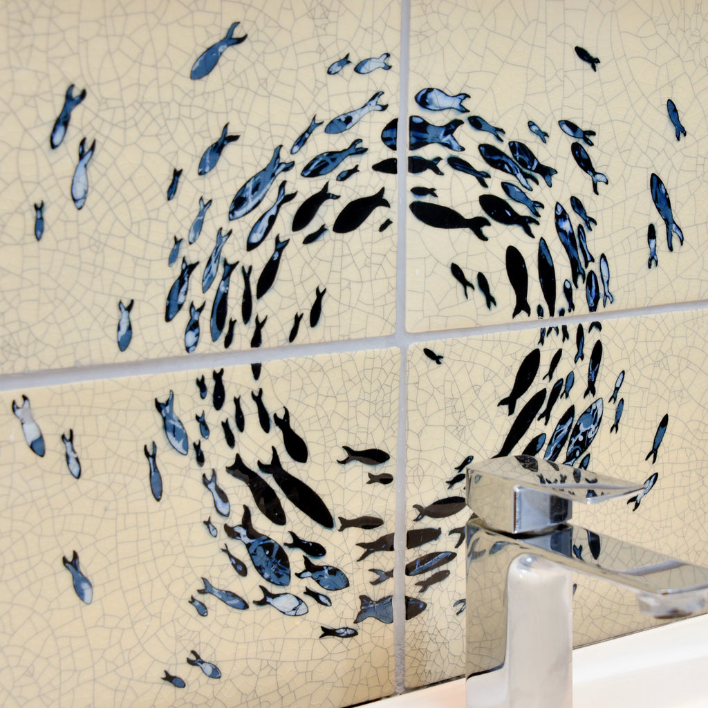 Encaustic ceramic tiles sink splash back with hand carved and inlaid black and grey school of fish.