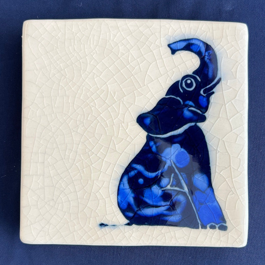 Square ceramic coaster with a blue elephant design on a crackle glaze background