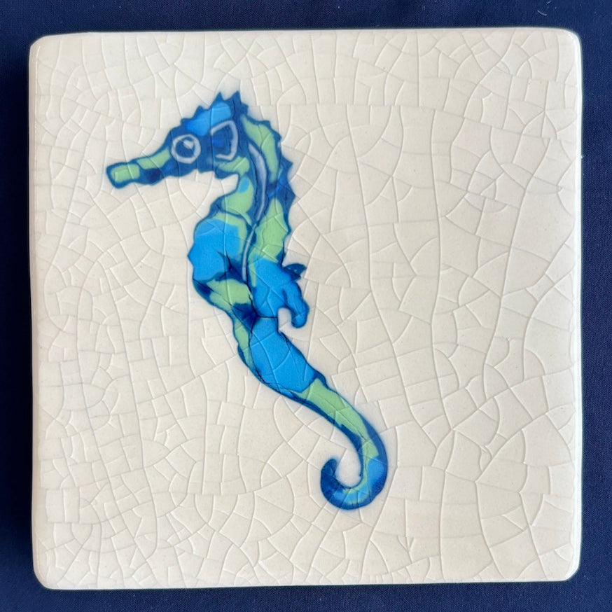 Square ceramic coaster with a blue whale design on a crackle glaze background