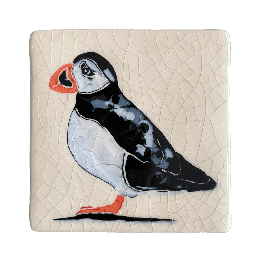 Square ceramic coaster with a puffin design on a crackle glaze beige background